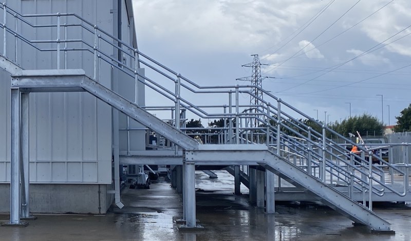 Galvanised access staircases and platforms at a commercial site